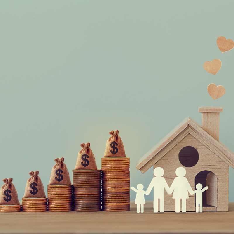 Home Equity Line of Credit - pennies stacked up to a mini house and family