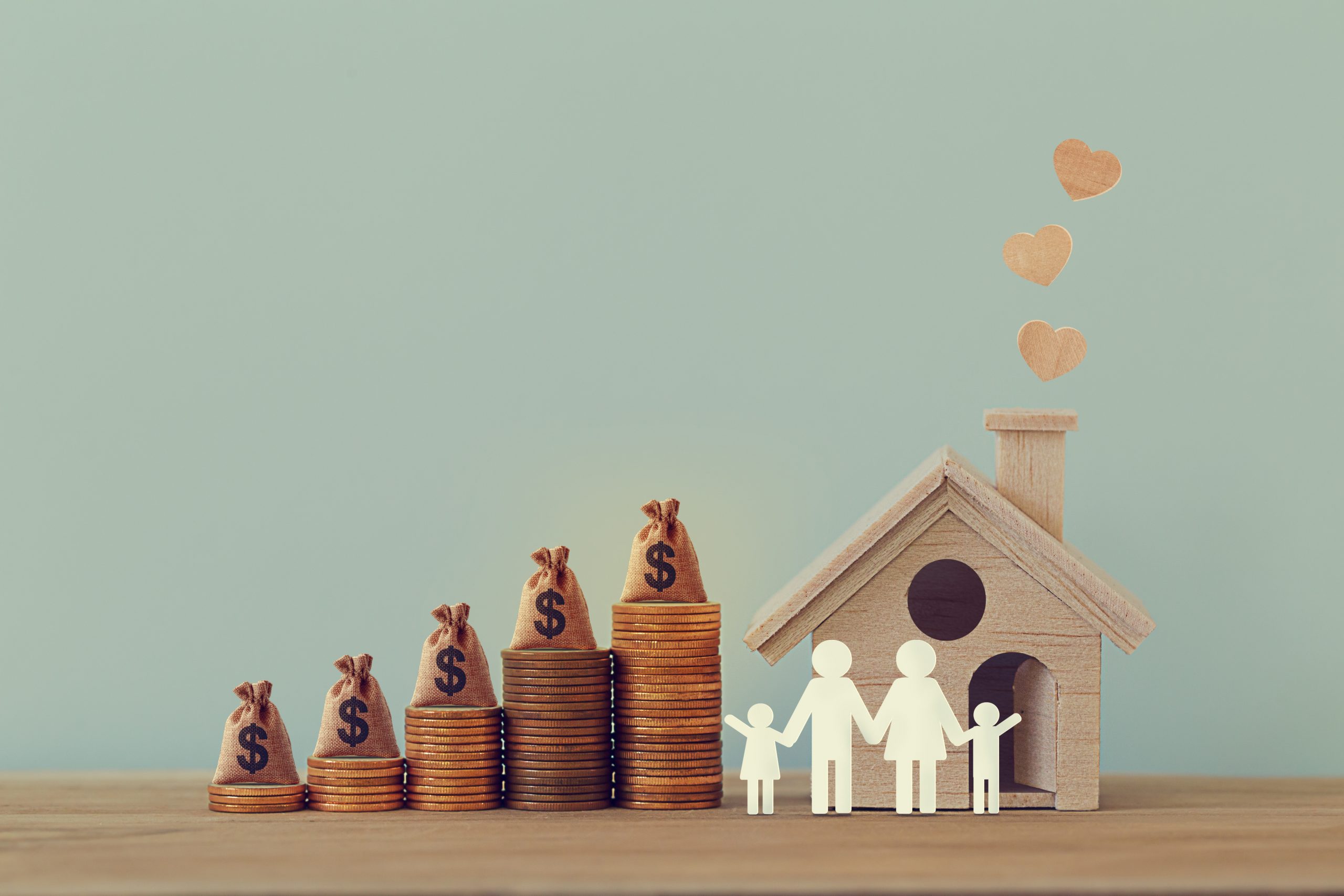 Home Equity Line of Credit - pennies stacked up to a mini house and family