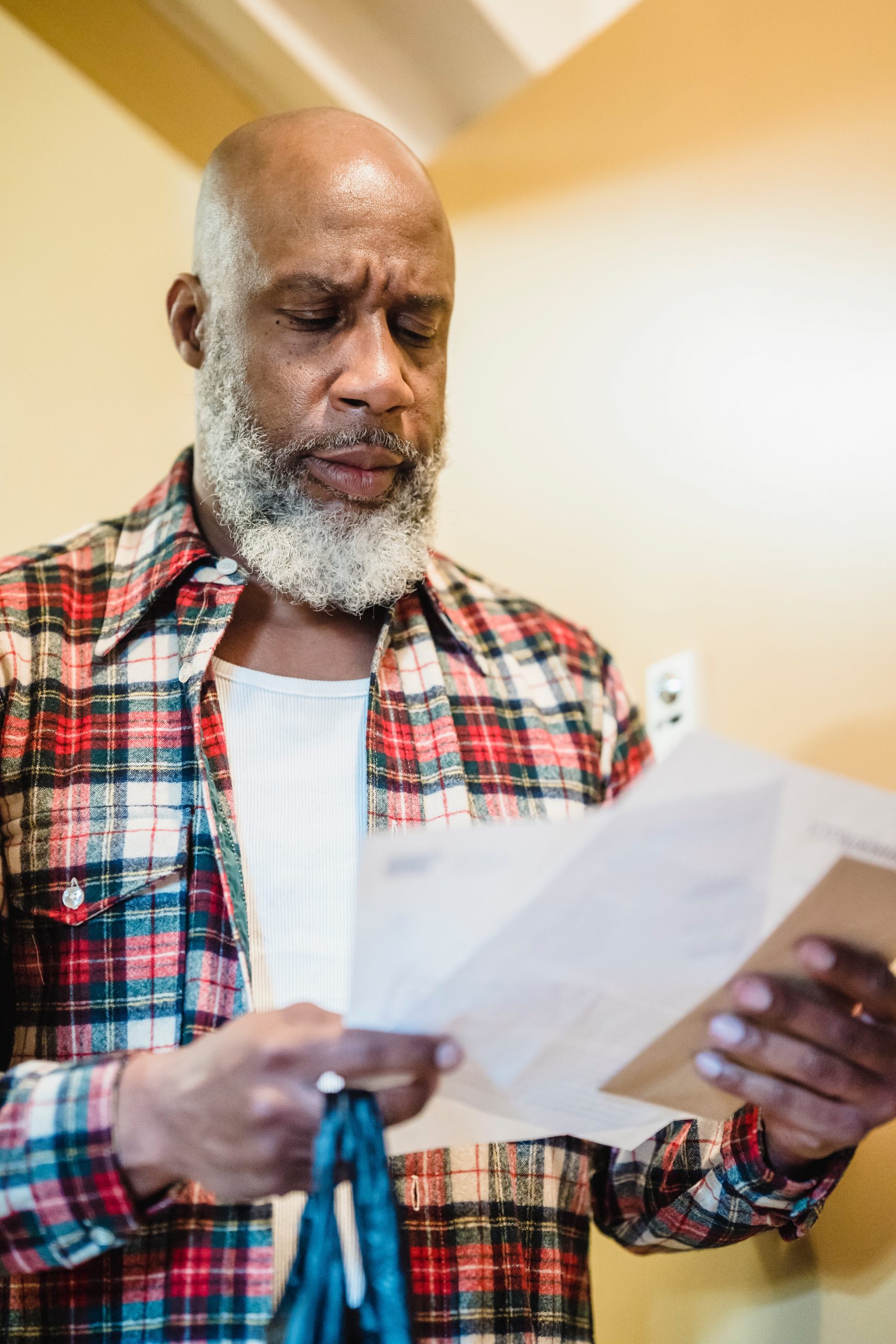 man holding bills that need to be paid: 7 common financial mistakes