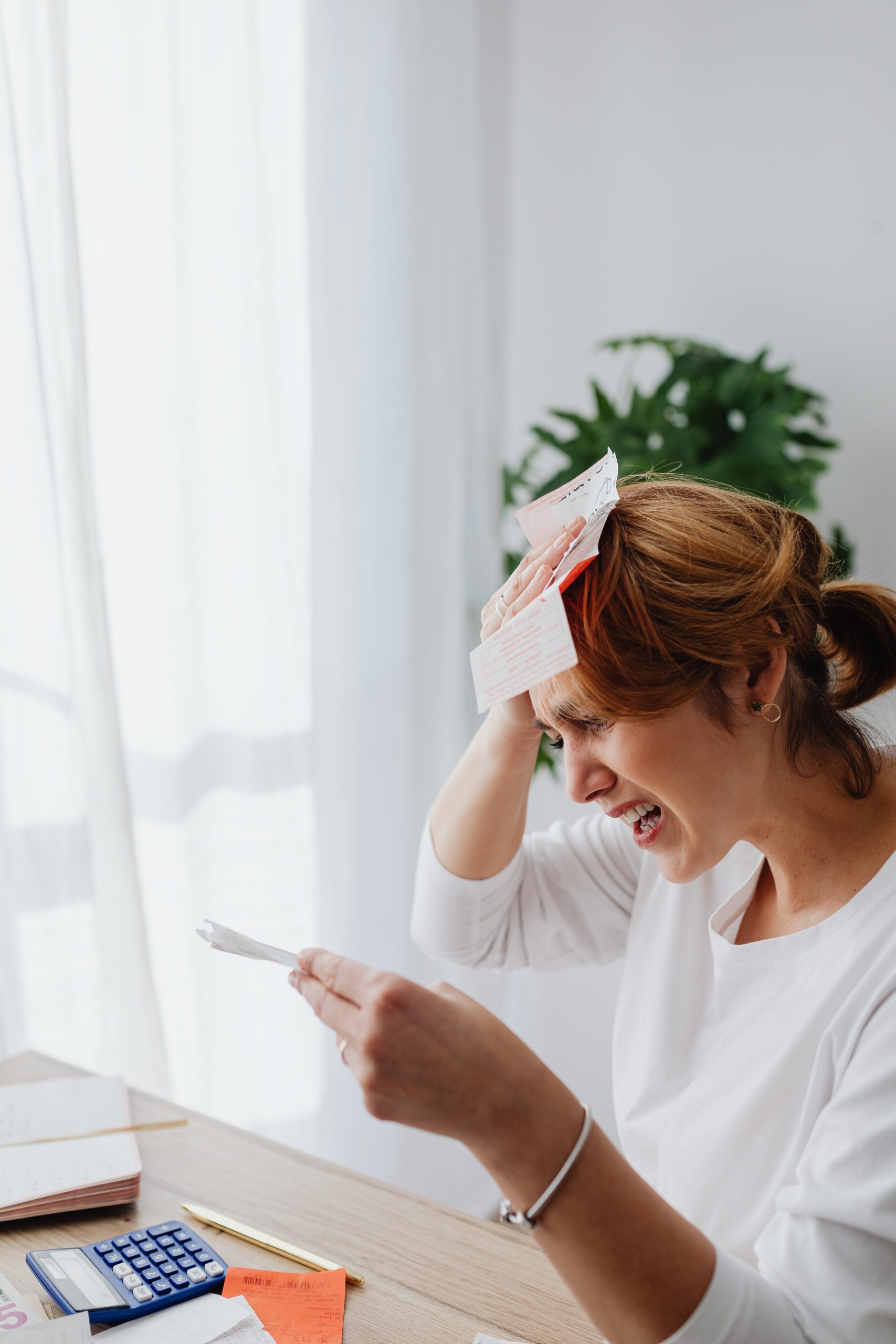 woman finding error on her medical bill, astonished