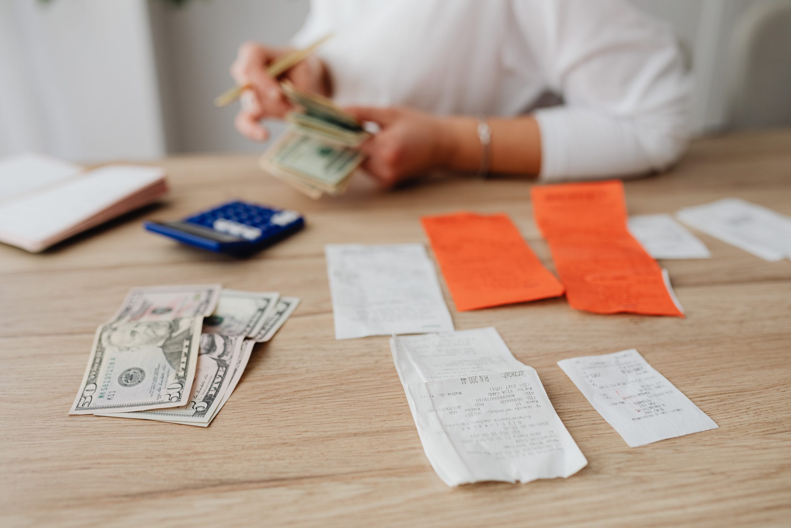 woman counting money to pay her medical bills