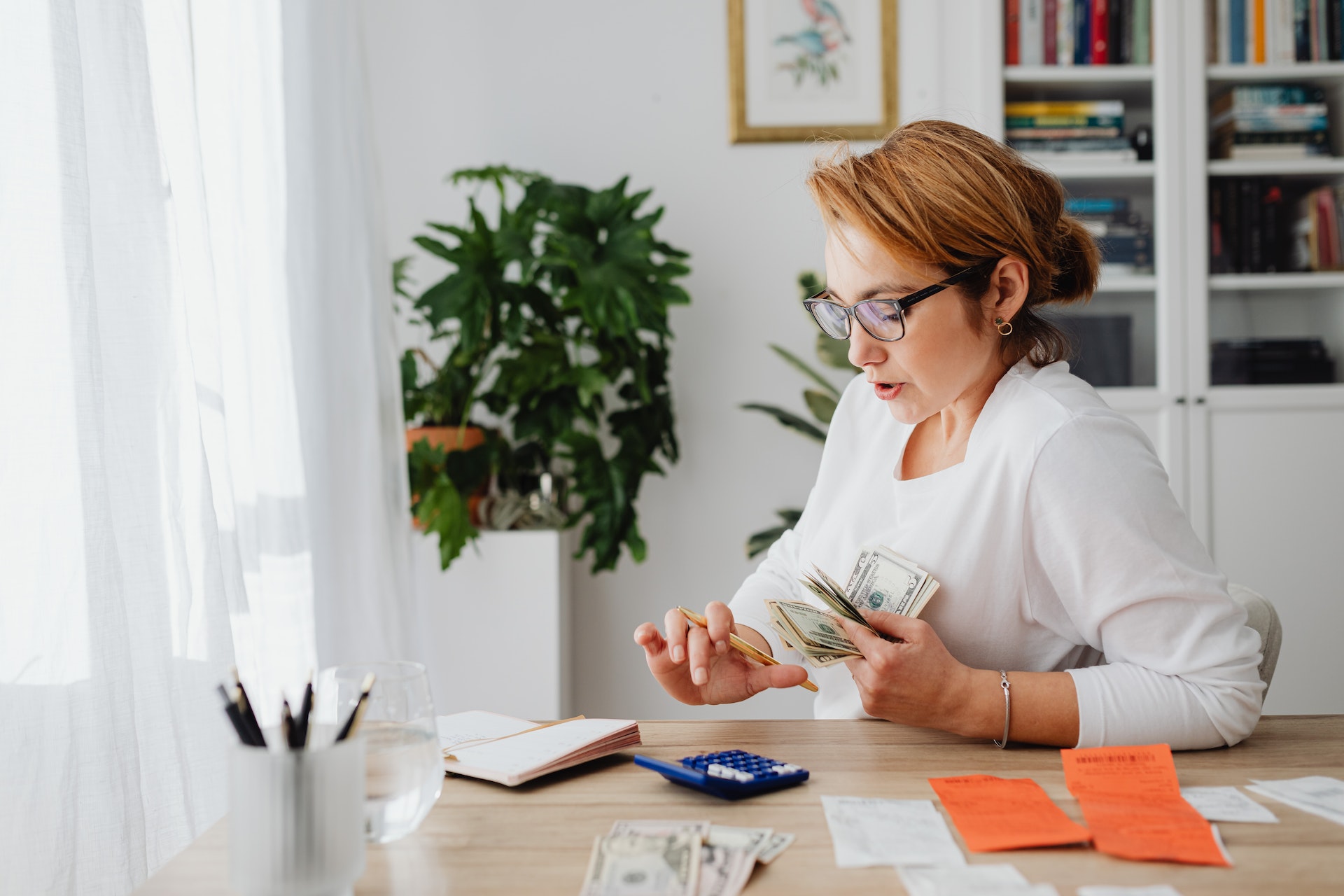 woman sitting at table learning about how to manage her money